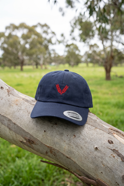 Navy dad cap with red wheat emblem on gum branch